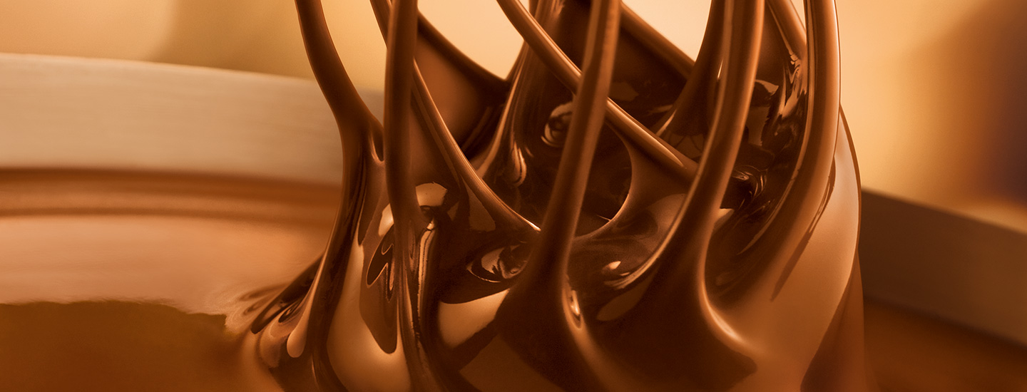 Fine Lindt chocolate is stirred with whisks