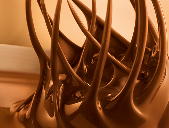 Fine Lindt chocolate is stirred with whisks